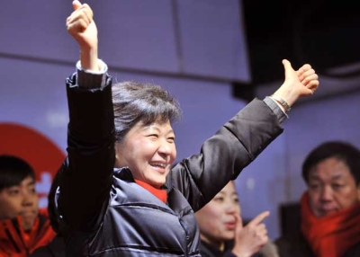South Korean presidential candidate Park Geun-hye (C) of the ruling New Frontier Party waves to her supporters in Seoul on Dec. 18, 2012, one day before her historic victory. (Jung Yeon-Je/AFP/Getty Images) 