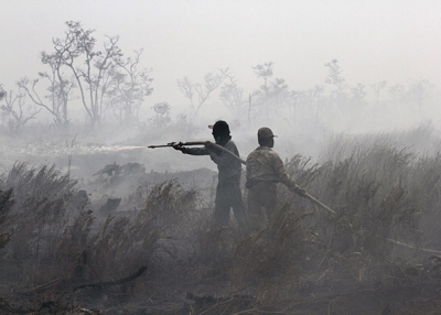 Indonesian firefighters work to extinguish a peatland fire in South Sumatra on September 11, 2015. (Abdul Qodir/AFP/Getty Images)