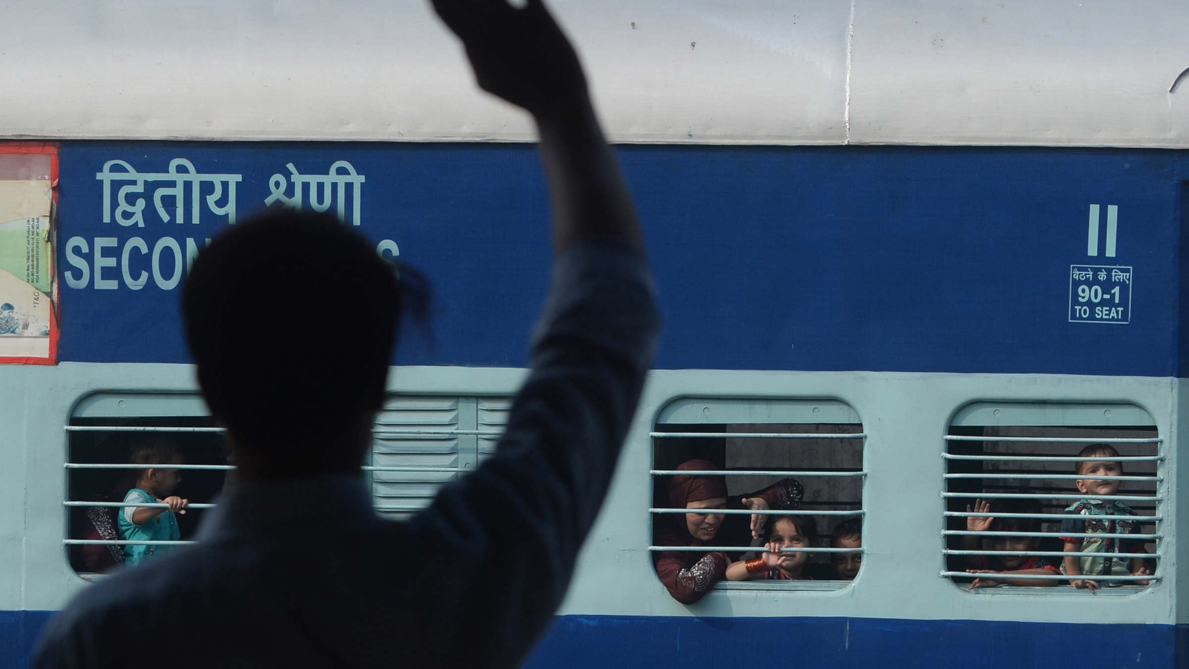 A Pakistani man waves to his Indian Muslim relatives on their departure to India via the Samjhauta Express train, also called the Friendship Express that ran between Delhi and Attari in India and Lahore in Pakistan, at the railway station in Lahore on August 8, 2019. Service was suspended in August 2019 amid worsening diplomatic tensions after India revoked the special status of the state of Jammu and Kashmir.