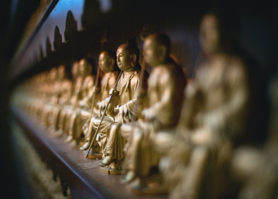 selective focus gold buddha sitting statue on the wall, Fo Guang Shan Chu Un Temple, Cebu City, Philippines